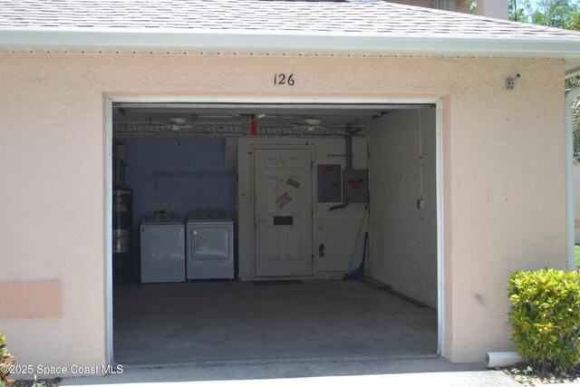 126 Plover Ln Unit 632, Rockledge, FL 32955 - garage featuring washer and clothes dryer, electric panel, and water heater
