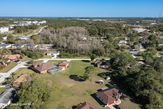 birds eye view of property with a forest view