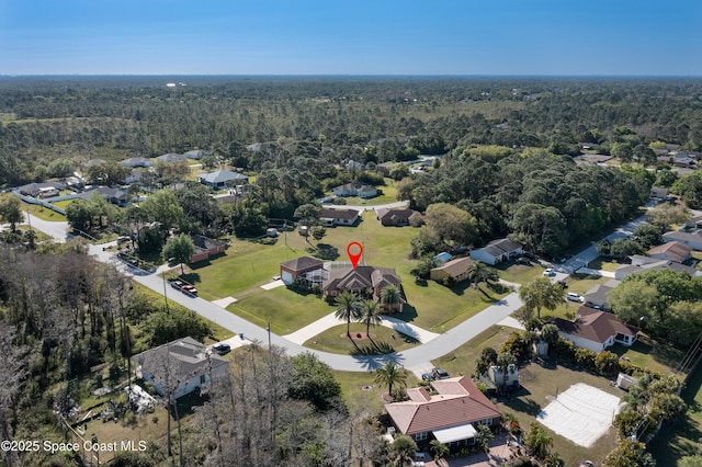 birds eye view of property featuring a wooded view