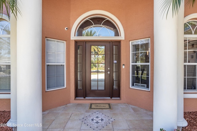 entrance to property featuring stucco siding