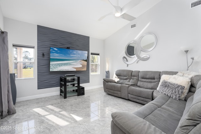 living area with visible vents, baseboards, and a healthy amount of sunlight