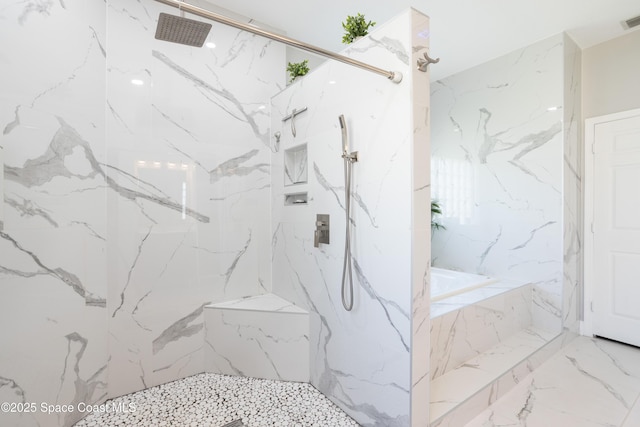 full bathroom with a marble finish shower, visible vents, a bath, marble finish floor, and stone wall