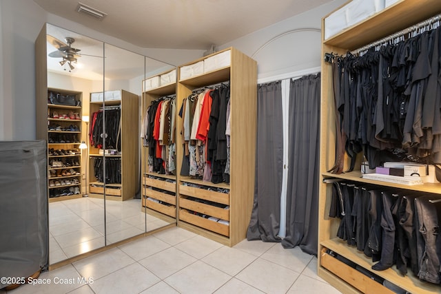 spacious closet featuring tile patterned floors, visible vents, and ceiling fan