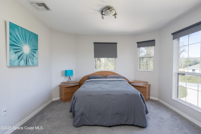 carpeted bedroom featuring baseboards and visible vents