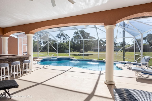 view of swimming pool with a patio, a lawn, a lanai, and outdoor dry bar