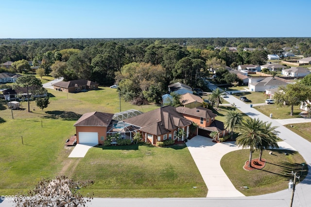 birds eye view of property featuring a view of trees and a residential view