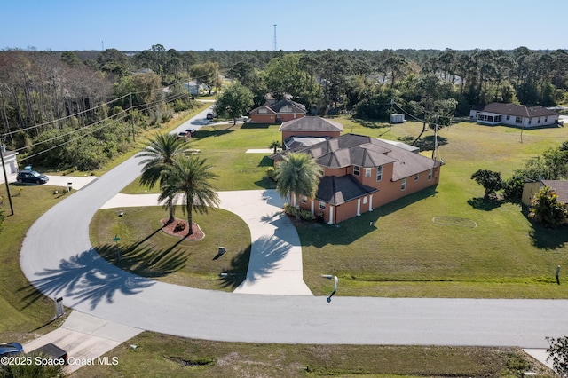 birds eye view of property with a wooded view