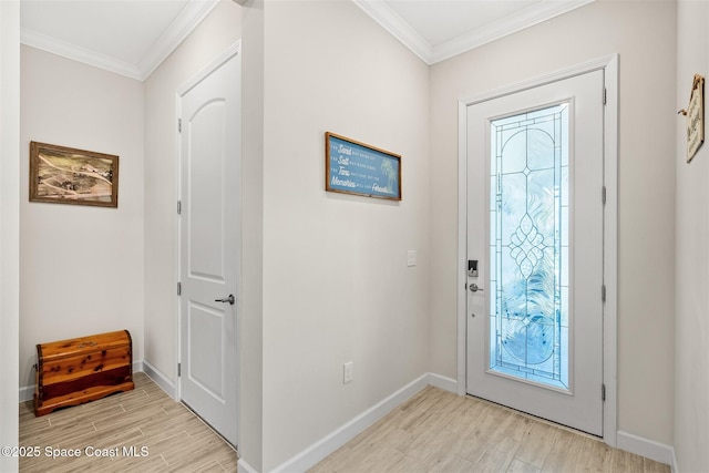 entryway with light wood-style flooring, baseboards, and ornamental molding