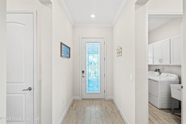 entrance foyer featuring a wealth of natural light, crown molding, and light wood-style floors