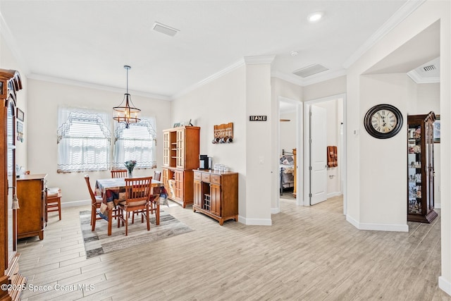 dining space with light wood-type flooring, baseboards, and ornamental molding