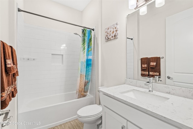 full bath with toilet, shower / bath combo with shower curtain, and vanity