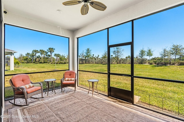 unfurnished sunroom featuring plenty of natural light and ceiling fan