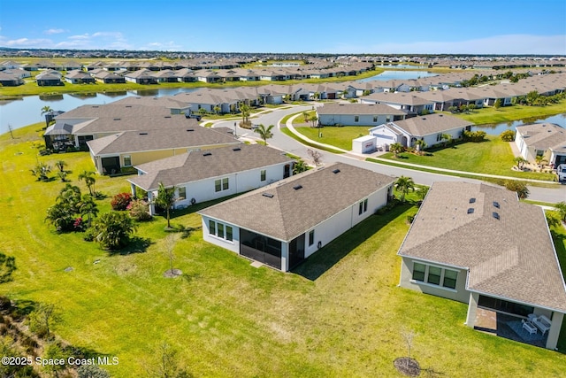 bird's eye view with a residential view and a water view