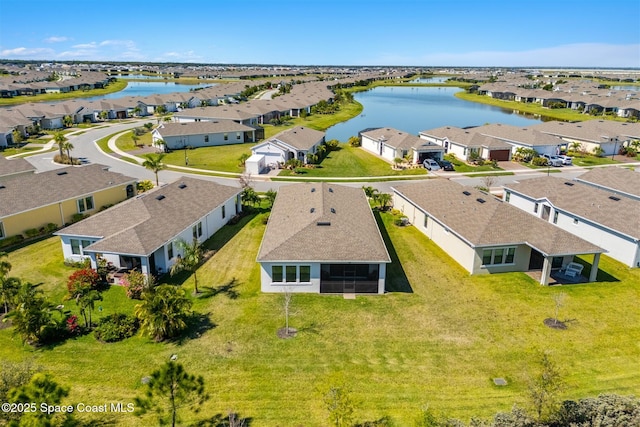 drone / aerial view with a residential view and a water view