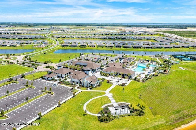 drone / aerial view featuring a residential view and a water view