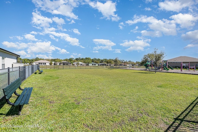 view of yard with playground community and fence