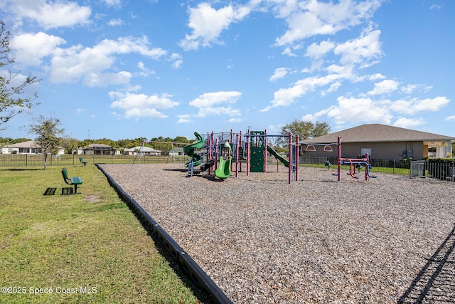 communal playground with a yard and fence