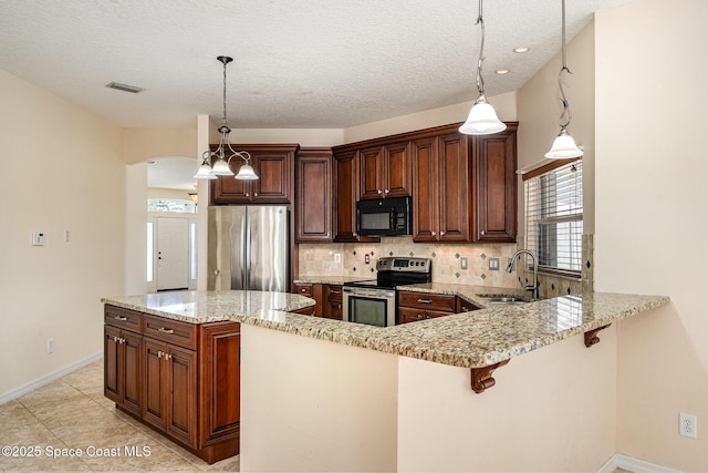 kitchen featuring a sink, light stone counters, backsplash, stainless steel appliances, and arched walkways