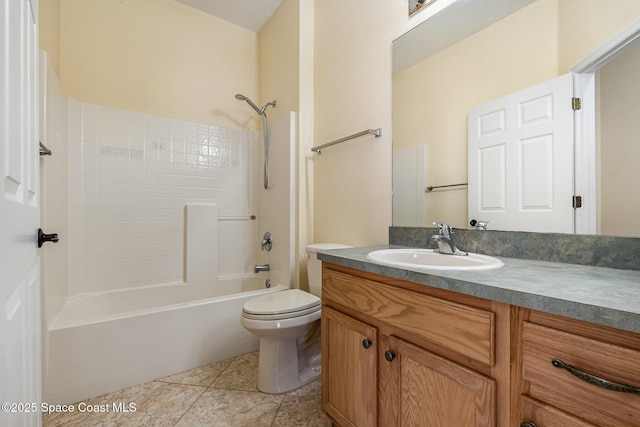 bathroom featuring tile patterned flooring, toilet, vanity, and shower / bathing tub combination