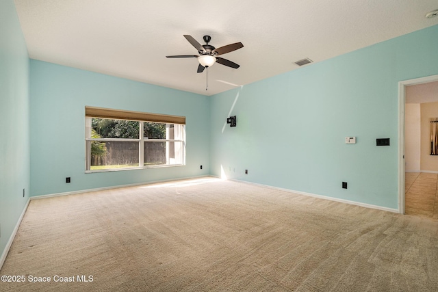 spare room with visible vents, baseboards, ceiling fan, and carpet flooring