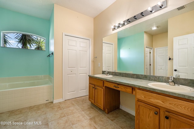 full bath featuring a sink, visible vents, a garden tub, and double vanity