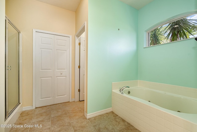 bathroom with tile patterned floors, baseboards, a garden tub, and a stall shower