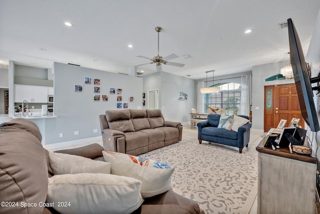 living room with visible vents, baseboards, ceiling fan, light tile patterned floors, and recessed lighting