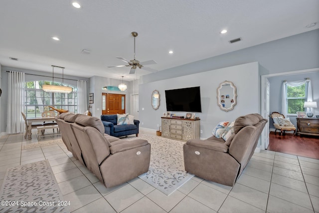 living room with light tile patterned floors, visible vents, plenty of natural light, and recessed lighting