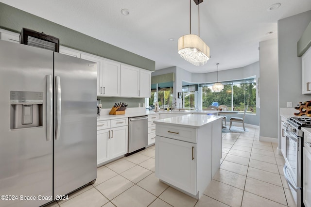 kitchen with white cabinetry, a kitchen island, appliances with stainless steel finishes, and light countertops