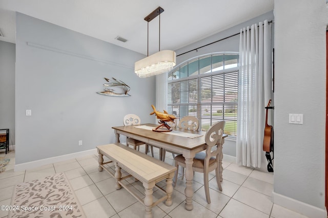 dining area featuring light tile patterned flooring, visible vents, and baseboards