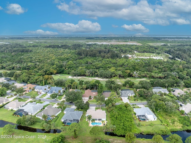 birds eye view of property featuring a wooded view and a residential view