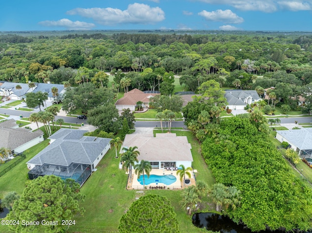 drone / aerial view with a residential view and a wooded view