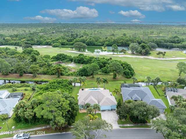 bird's eye view featuring a water view and a wooded view