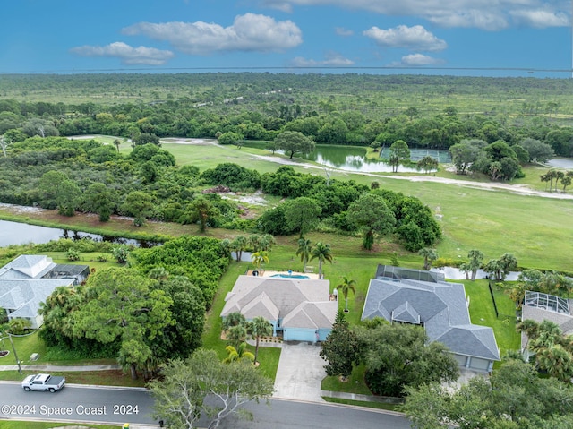 aerial view with a wooded view and a water view