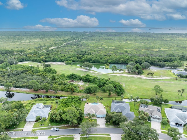 aerial view with a residential view, a wooded view, and a water view