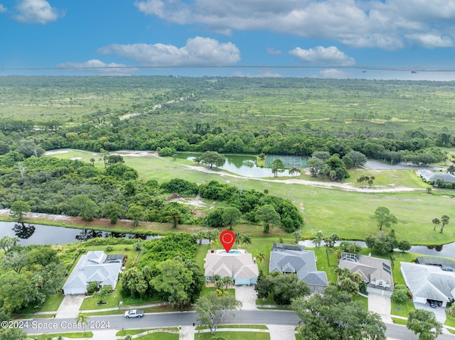 birds eye view of property with a residential view, a water view, and a wooded view