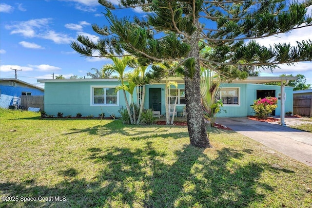 489 Seacrest Ave, Merritt Island, FL 32952 - ranch-style house featuring driveway, a front yard, and fence
