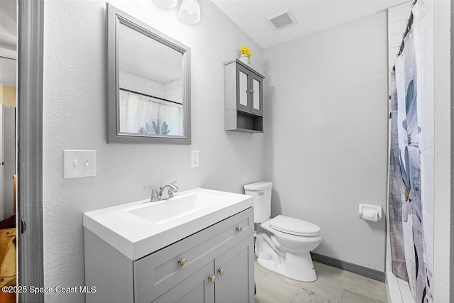 489 Seacrest Ave, Merritt Island, FL 32952 - bathroom featuring visible vents, toilet, a shower with shower curtain, baseboards, and vanity