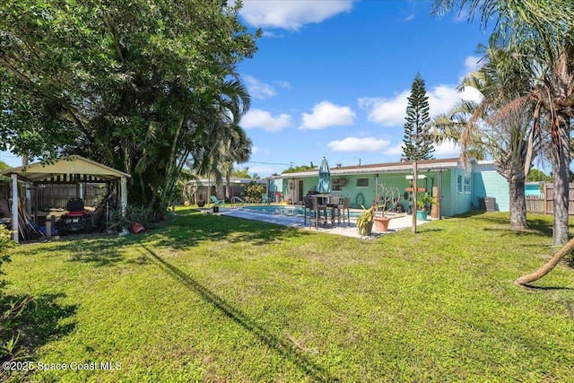 489 Seacrest Ave, Merritt Island, FL 32952 - view of yard featuring a detached carport, a fenced backyard, an outdoor pool, central AC, and a patio area
