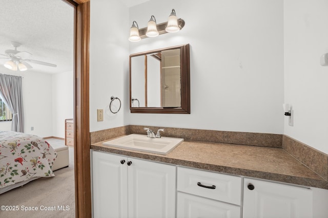 ensuite bathroom featuring ensuite bath, vanity, and a ceiling fan