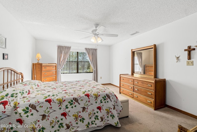 carpeted bedroom featuring visible vents, ceiling fan, a textured ceiling, and baseboards