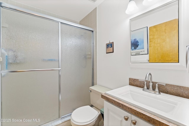 full bathroom featuring vanity, toilet, and a stall shower