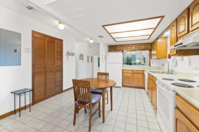 kitchen featuring under cabinet range hood, light countertops, electric panel, white appliances, and a sink