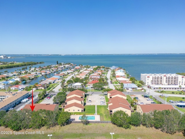 drone / aerial view with a residential view and a water view