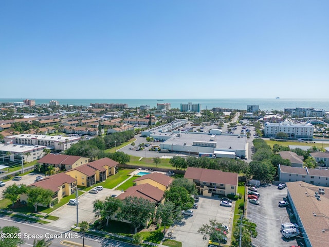 birds eye view of property featuring a city view and a water view