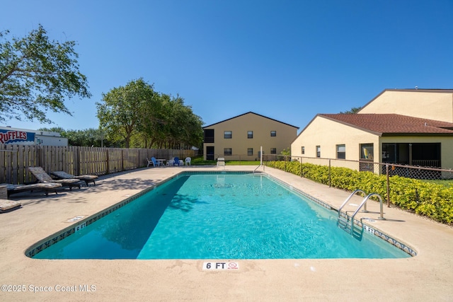 pool featuring a patio and fence