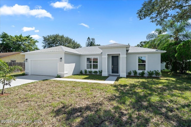 view of front of home featuring stucco siding, driveway, fence, a front yard, and an attached garage