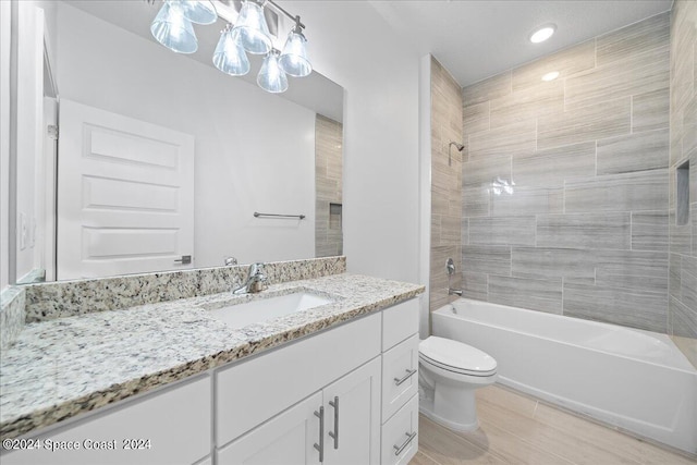 bathroom with shower / bathing tub combination, toilet, and vanity