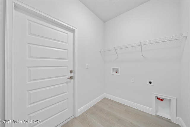 laundry area featuring baseboards, washer hookup, laundry area, light wood-style flooring, and hookup for an electric dryer