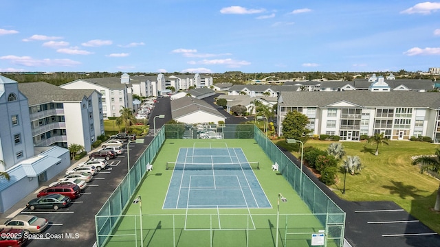 view of sport court featuring fence and a residential view